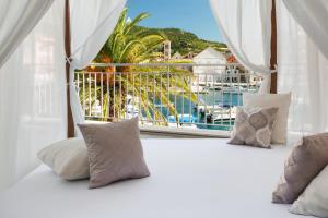 a bedroom with a window with a view of a marina at Adriana Hvar Spa Hotel in Hvar