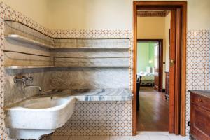 a bathroom with a tub and a sink on a wall at Carlotta Flexyrent Apartment in Rapallo