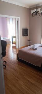 a bedroom with a bed and a chair in it at The Athens Museum Penthouse 120sqm Lycabettus View in Athens