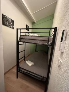 2 stapelbedden in een kamer met een muur bij La Mezza de Gruissan in Gruissan