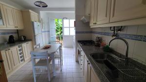 a kitchen with a sink and a counter top at The Best Atlantic Ocean View in Câmara de Lobos