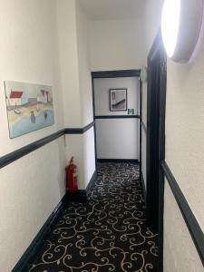 a hallway with a room with a fire hydrant at Trinity Guest House in Hartlepool