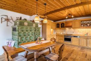 a kitchen with a wooden table and a wooden ceiling at Dalblick in Oberharmersbach