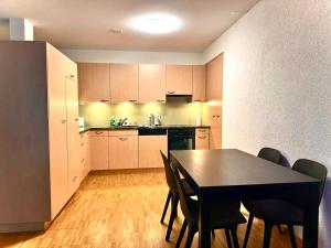 a kitchen with a table and chairs in a room at Interlaken Best View Deluxe Apartment in Interlaken