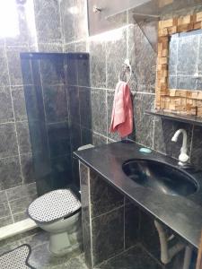 a bathroom with a black sink and a toilet at Apartamento Anchieta 7 Belo in Rio de Janeiro