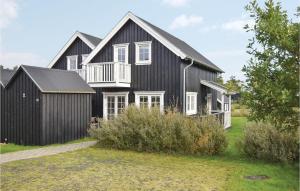 a black house with a gambrel at Shjlandet in Gjern