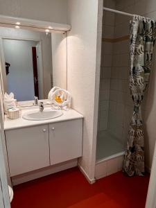 a bathroom with a sink and a shower at Neoresid - Résidence Republique in Douai