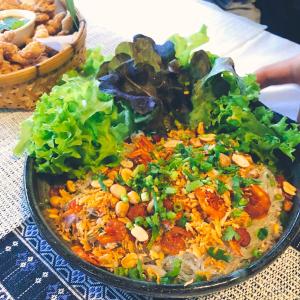 a plate of food sitting on a table at ม่วนโฮม muan home café&stay in Ban Don