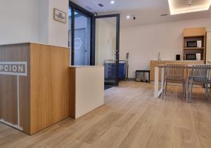 an office with a reception area with chairs and a table at Aloha Surf Hostel in Somo