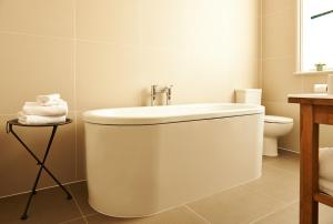 a white bathroom with a sink and a toilet at The Bull and The Hide in London