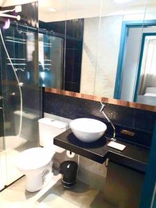 a bathroom with a sink and a toilet at Melhor custo benefício: elegância e conforto. in Maringá