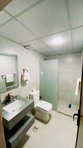 a bathroom with a toilet and a sink and a shower at Yellow Star Camp Wadi Rum in Wadi Rum