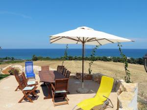 einen Tisch und Stühle mit einem Sonnenschirm und dem Meer in der Unterkunft Apartment Girasole by Interhome in Termoli