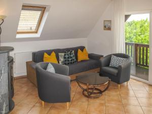 a living room with a couch and two chairs at Holiday Home Müritz Ferienpark Röbel-22 by Interhome in Röbel