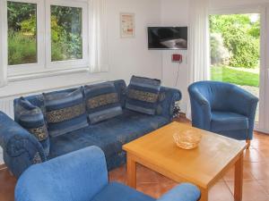 a living room with a couch and two chairs and a table at Holiday Home Müritz Ferienpark Röbel-22 by Interhome in Röbel +38 photos