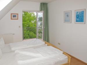 two beds in a room with a window at Holiday Home Müritz Ferienpark Röbel-23 by Interhome in Röbel