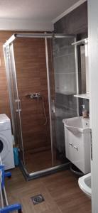 ein Bad mit einer Dusche und einem Waschbecken in der Unterkunft Apartment, sweet home in the town-center. in Bitola