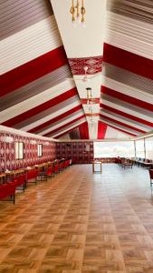 a large room with red and white walls and benches at Yellow Star Camp Wadi Rum in Wadi Rum