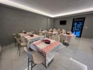 a conference room with tables and chairs and a tv at Hotel Prima in Istanbul