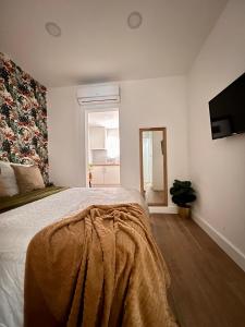 巴塞隆納的住宿－Crysoyle Apartment Barcelona Next to Camp Nou，一间卧室配有一张床铺,床上有毯子
