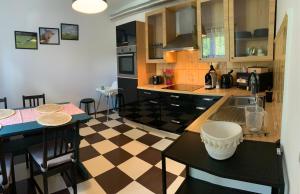 a kitchen with a checkered floor at Noclegi Little Sheep in Chojna