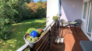 a balcony with a planter on a fence with a garden at Ferienwohnung Asal in Waldbronn