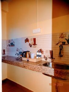 a kitchen with a sink and a counter top at Hotel Shree Ram SIA Residency in Gaya
