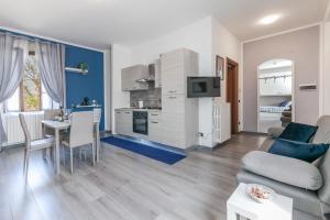 a kitchen and living room with a couch and a table at RHOme 8 - 4 minutes from Rho Fiera in Rho