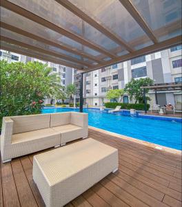 a patio with a couch and a pool in a building at Horizons 101 Condo in Cebu City in Cebu City