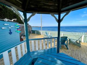 a blue porch with a view of the ocean at Hill Crest - cliff top cottage with stunning views in Cullen