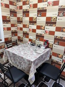 a dining room with a table and two chairs at Khujand comfort in Khujand