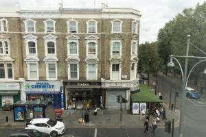 um carro branco estacionado em frente a um edifício em THE KNIGHT OF NOTTINGHILL em Londres