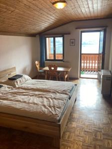 1 dormitorio con 1 cama, mesa y sillas en Privatzimmer am See, en Hallstatt