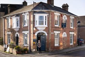 a woman standing in front of a brick building at Britannia House in Lymington