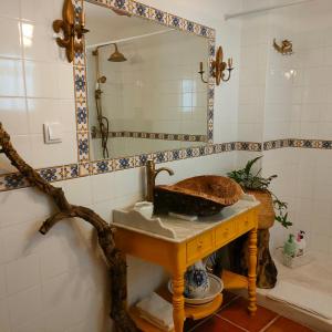 a bathroom with a sink and a mirror at Casa da Muralha in Estremoz
