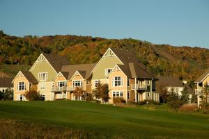 a large house on a hill with a green yard at Blue Mountain Resort Home Collection in Blue Mountains