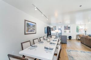 a dining room with a white table and chairs at Ice House 317 condo in Telluride +40 photos