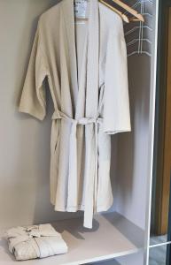 a robe hanging on a rack in a closet at Fonte Seca GuestHouse in Leiria