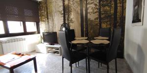 a dining room with a table and black chairs at MESTA CENTRO in Soria