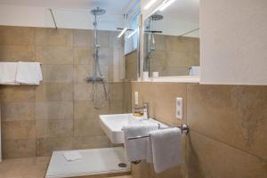 a bathroom with a sink and a shower at Ferienwohnung Tödiblick in Wangen im Allgäu +12 photos