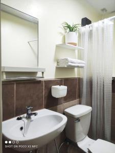 a bathroom with a sink and a toilet and a mirror at AR04 H&Bs BrandNew1BR Smart Unit w Alexa in Davao City +3 photos