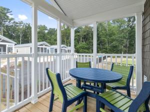a screened porch with a blue table and chairs at Shore Point Cottages in Ocean City