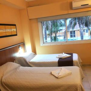 a hotel room with two beds and a window at Saint Tropez Hotel in Villa Carlos Paz