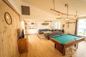 a living room with a pool table in it at Oleron Surf House in Allards