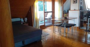 a bedroom with a bed and a table and chairs at Komfort Apartman in Eger