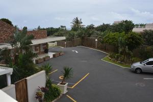 a parking lot with a car parked in it at Sea Lodge G01 in Durban