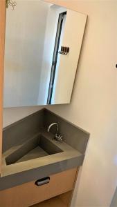 a bathroom sink with a mirror above it at Loft Veneto in Maringá