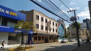 a city street with cars parked on the street at Hotel Mattes in Joinville