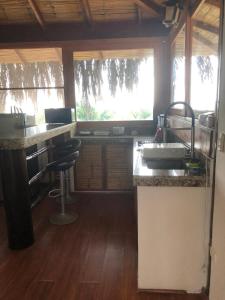 a kitchen with a sink and a counter top at Aquamare Bungalows in Cruz de Pizarro