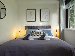 a bedroom with a large bed with two pillows at The Regent House in Brighton & Hove